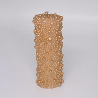 Candles with textured bead patterns